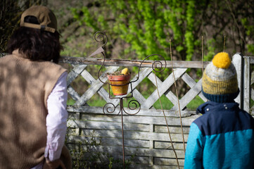 persons in the garden looking at an Easter egg