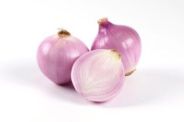 Fototapeta premium Red onion, peeled, halved, placed close-up on a white background It is a vegetable that can be eaten raw.