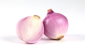 Red onion, peeled, halved, close-up placed on a white background