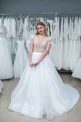 pretty bride chooses best elegant wedding fashion dress in salon