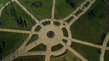 Pedestrian paths in the city park. Flight over the spring city park. Aerial photography.