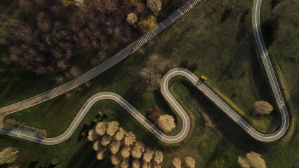 A winding bike path in a city park. Flight over the spring city park. Aerial photography.