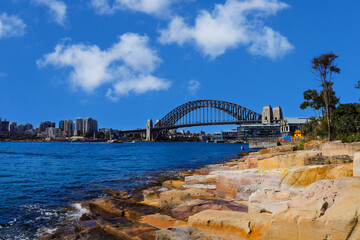 Fototapeta premium Sydney Harbour Australia with nice colours in the sky. Nice blue water of the Harbour, high rise offices and residential buildings of the City in the background, NSW Australia