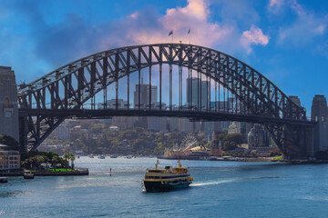 Naklejka premium Sydney Harbour Australia with nice colours in the sky. Nice blue water of the Harbour, high rise offices and residential buildings of the City in the background, NSW Australia