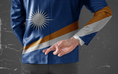 Businessman Jacket with Flag of Marshall Islands with his fingers crossed behind his back
