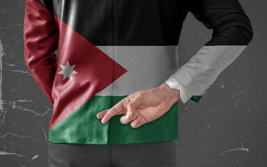 Businessman Jacket with Flag of Jordan with his fingers crossed behind his back