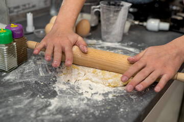 breaking eggs with women's hands into flour to make dough for cakes.