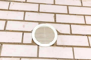 Ventilation grille, for airflow in building under construction with metal ribs and fasteners for a wall of concrete or brick.