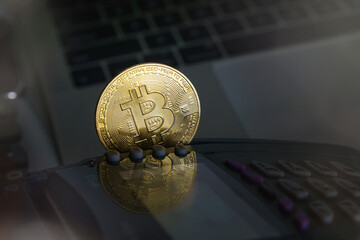 Bitcoin btc crypto currency as decentralized finance payment on credit card machine, calculator, mobile phone. Concept of contactless payment