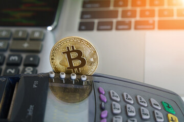 Bitcoin btc crypto currency as decentralized finance payment on credit card machine, calculator, mobile phone. Concept of contactless payment