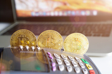 Three Bitcoin btc crypto currency as decentralized finance payment on credit card machine, laptop, mobile phone. Concept of contactless payment
