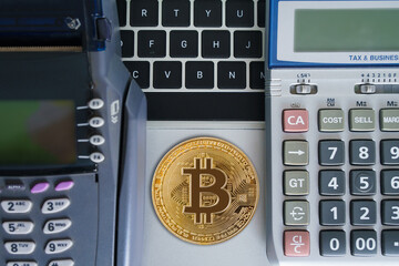 Bitcoin btc crypto currency as decentralized finance payment on credit card machine, calculator, mobile phone. Concept of contactless payment