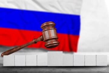 Classic judge's gavel with wooden cubes for the text with Russian flag, Concept on the of sanctions...