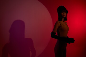 woman on stage spotlight shadows posing red neon