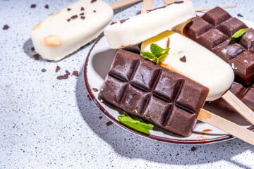 Chocolate and vanilla popsicles, Classic dark brown cocoa and milk cream ice cream lolly pops. Stack of various ice-cream lollies flatlay top view copy space