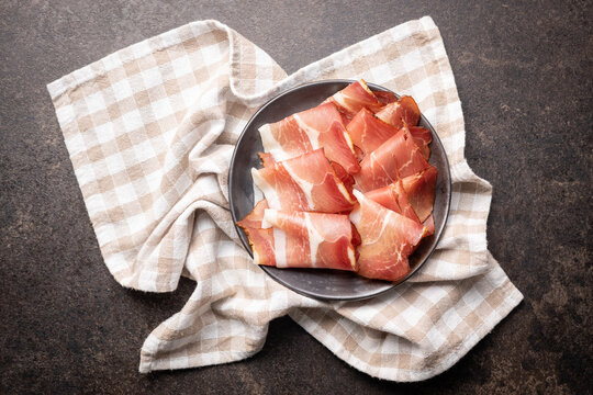 Sliced schwarzwald ham. Dried prosciutto ham on plate.