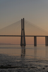sunrises at the basque bridge of gama in lisbon, colors of the golden hour of the morning. basque bridge of gama