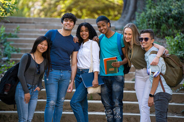 Group of young multiracial students waving at the camera on some stairs