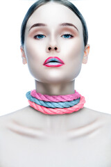 Beauty girl face, creative make-up, colorful rope necklace on neck, clean skin, blue eyes. Fashion and beauty concept