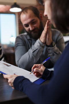 Startup Company Recruiter Reviewing Smiling Job Candidate CV While Sitting In Office Space. Thankful Applicant Smiling Heartily Because Of Career Oportunity While Woman Reading Man Resume.