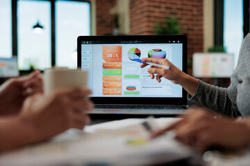 Close up of entrepreneur women analyzing marketing graphs using laptop computer working at business strategy in startup office. Executive managers brainstorming ideas for partnership project