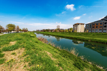 Obraz premium The River Monticano with the green banks in springtime, small town of Oderzo, Treviso province, Veneto, Italy, Europe.
