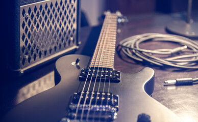 Fototapeta na wymiar Close-up, black electric guitar on a dark background.