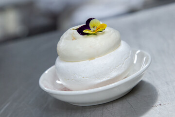 Dessert pavlova with summer fruit and berries meringue out of focus with grain