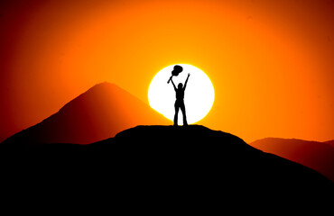 silhouette of a person on the top of the mountain