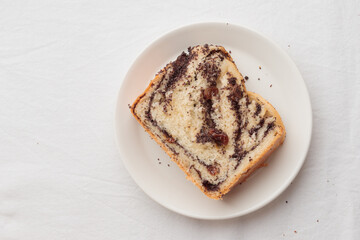 Piece of swirl homemade bread with poppy seeds