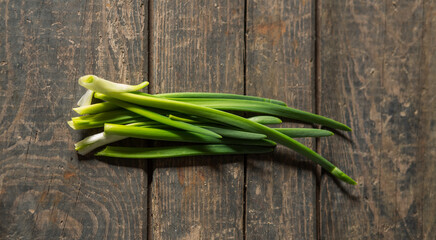 Green onions on a wooden table. Concept: market, food, vegetables, greens