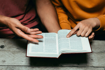 Christian couples read and study the Bible at home or in Sunday school. Sunday readings,...