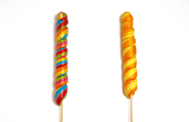 Two long multi-colored lollipops, isolated on a white background.