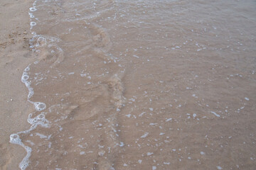 clear beach early morning with surf and sand no people out of focus with grain