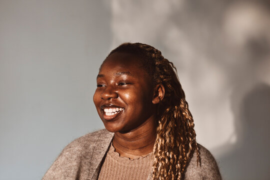 Happy woman looking away against white background
