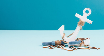White anchor and fish on a blue background, maritime sea life, sailing trip, summer vacation, tourism concept, harbor
