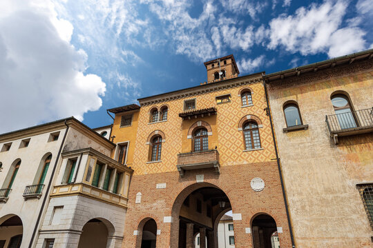 Frescoed palaces and medieval tower called Torresin. Small town of Oderzo in Treviso province, Veneto, Italy, Europe. Town square called Piazza Grande.