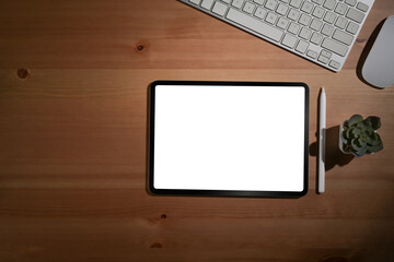 Flat lay mockup digital tablet, stylus pen and wireless keyboard on wooden table.