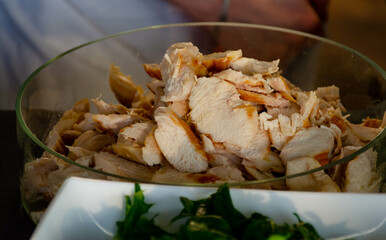pieces of fried chicken fillet in a transparent glass bowl close-up