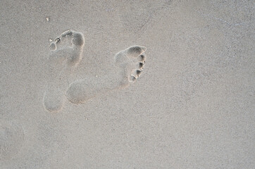 Footprints on wet sand. Footprints on the beach.