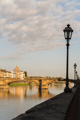 Ponte alle Grazie - bridge and old lamp post in Florence, Italy and Arno river 