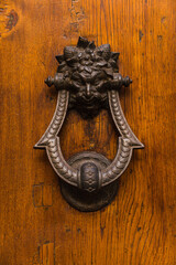 old door knocker on wooden door 