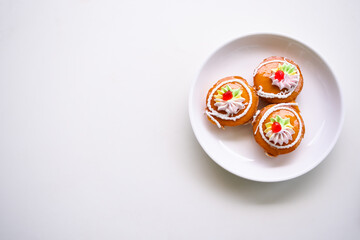 Thai Cake Traditional on plate.Kanom Kai. dessert snack original style Thai. Cake jam orange and cream homemade breakfast bakery. tasty and sweet food. hight sugar and hight fat. free space,flat lay.