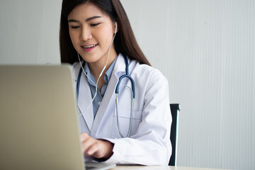 Asian woman doctor is online visiting with a patient on the internet application and Listening of...