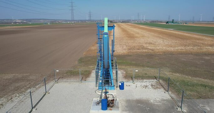 Oil drill on a field. Pump Jack extracting crude oil from an oil well. fossil fuel oil industry equipment.
