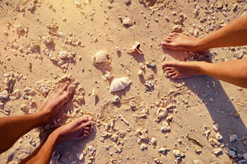 Vacation concept, Legs on the sand beach.