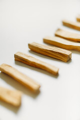 bunch of wooden palo santo sticks on a neutral background. soft focus, macro frame