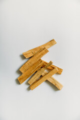 wooden palo santo sticks on a white background, incense set