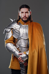The King. Handsome Medieval knight in armor and yellow cloak.