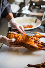 chinese chef cooking peking roasted duck at the kitchen of restaurant